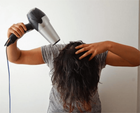 a-woman-drying-her-hair-upside-down
