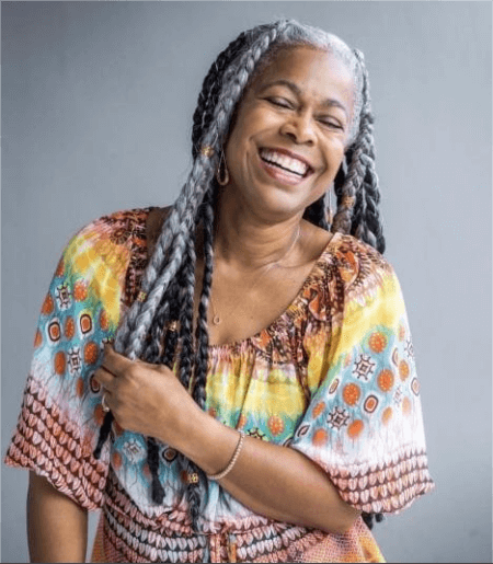 an-older-woman-smiling-with-her-ashy-braids